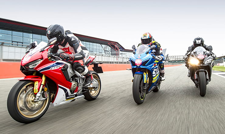 Three Superbikes race on track in close formation
